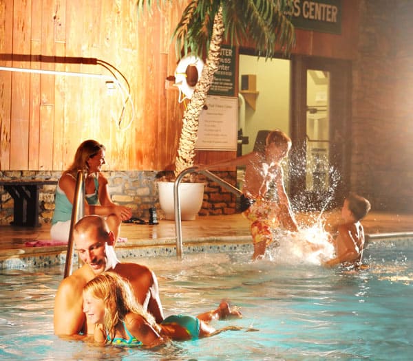 Family having fun swimming in a pool