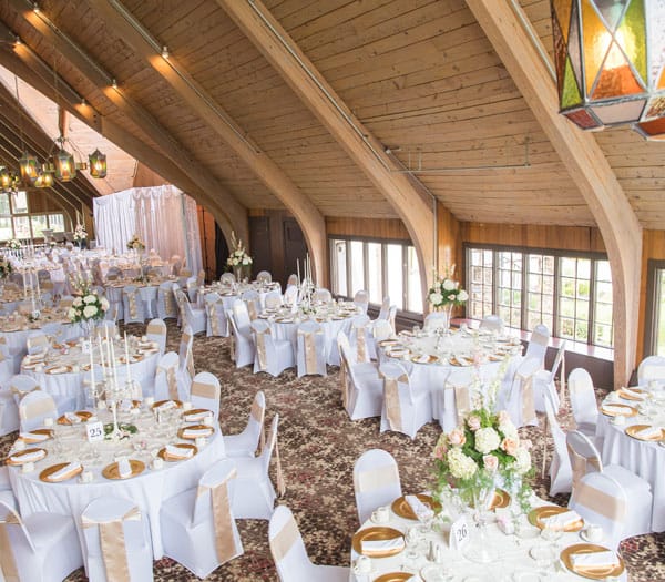 decorated wedding venue with tables and place settings