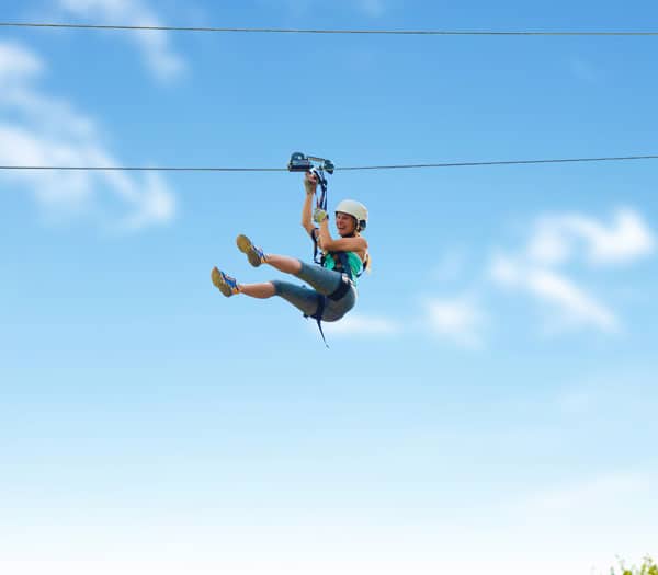 woman riding on giant dual zip line