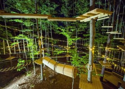 The Adventure Course at night lit up by hundreds of string lights
