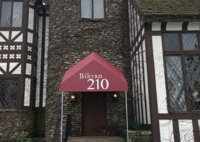 bistro 210 exterior front entrance with red awning