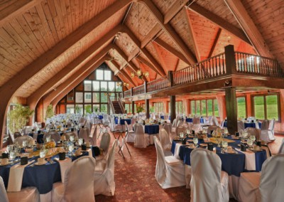 the lodge interior with tables set for wedding reception with blue accent colors