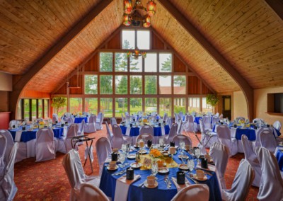 the lodge interior with tables set for wedding reception with blue accent colors