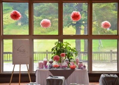 table with candy in front of window at the lodge during wedding reception