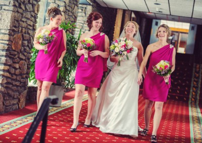 bride with bridesmaids smiling and having a good time