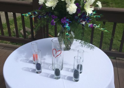 table with flowers at outdoor wedding ceremony