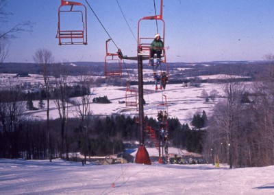 old historic photo of people on the peek n peak chairlift